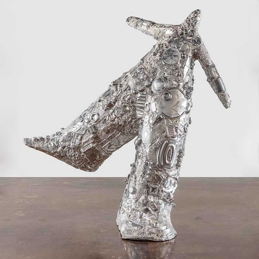 tom friedman staning next to his sculpture