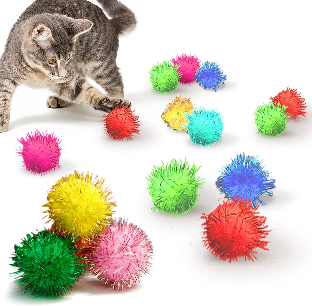 cat playing with multicolored tinsel pompoms