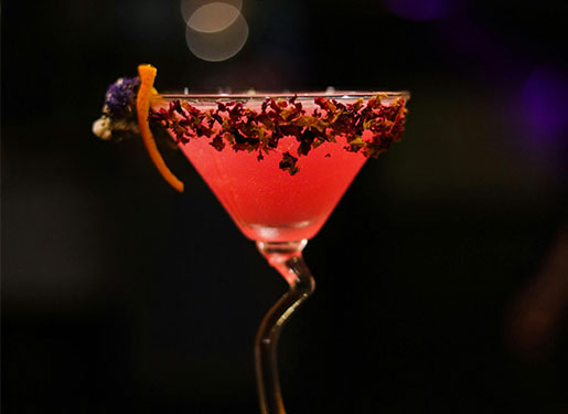 pink cocktail in martini glass