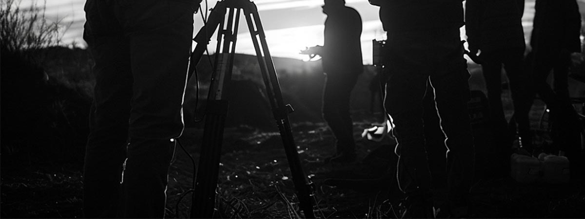 Historical Color Usage scene of film makers setting up a shot at sunset dusk