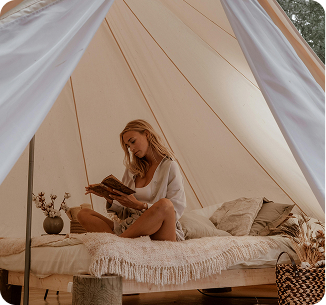 woman reading in a cozy tent